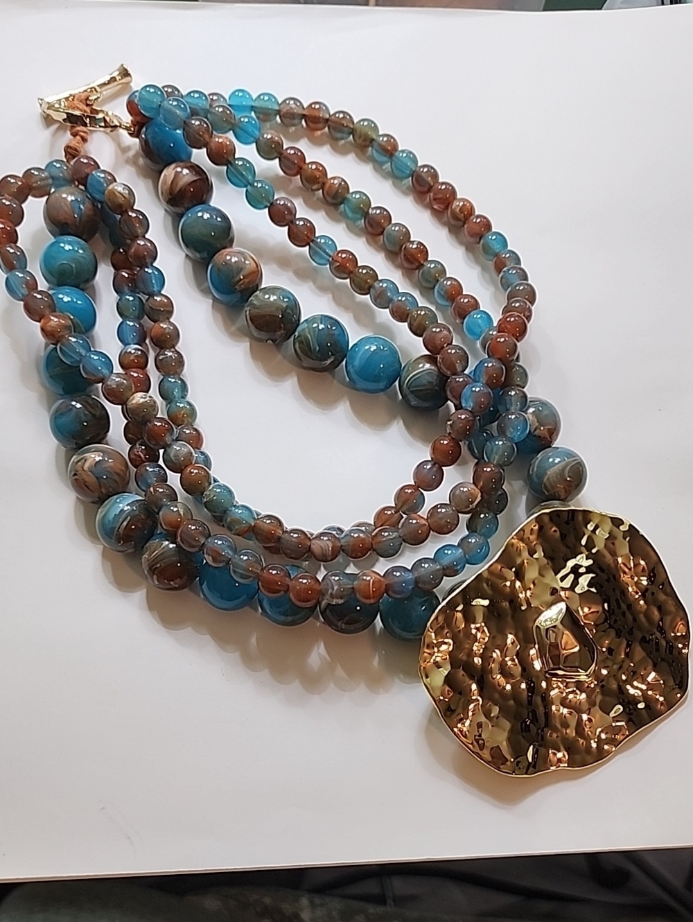 Multi-Strand Blue & Brown Beaded Necklace with Gold Hammered Pendant